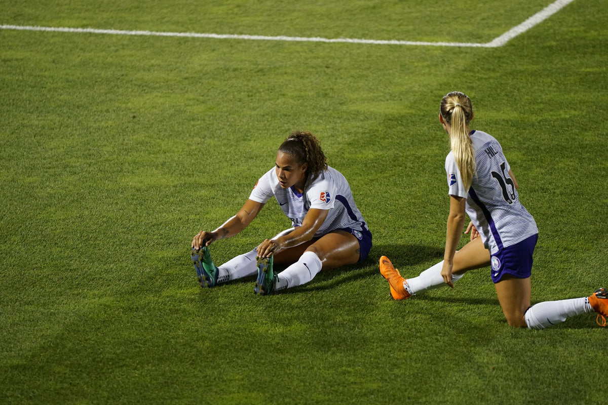 Soccer players stretching and recovering after a match